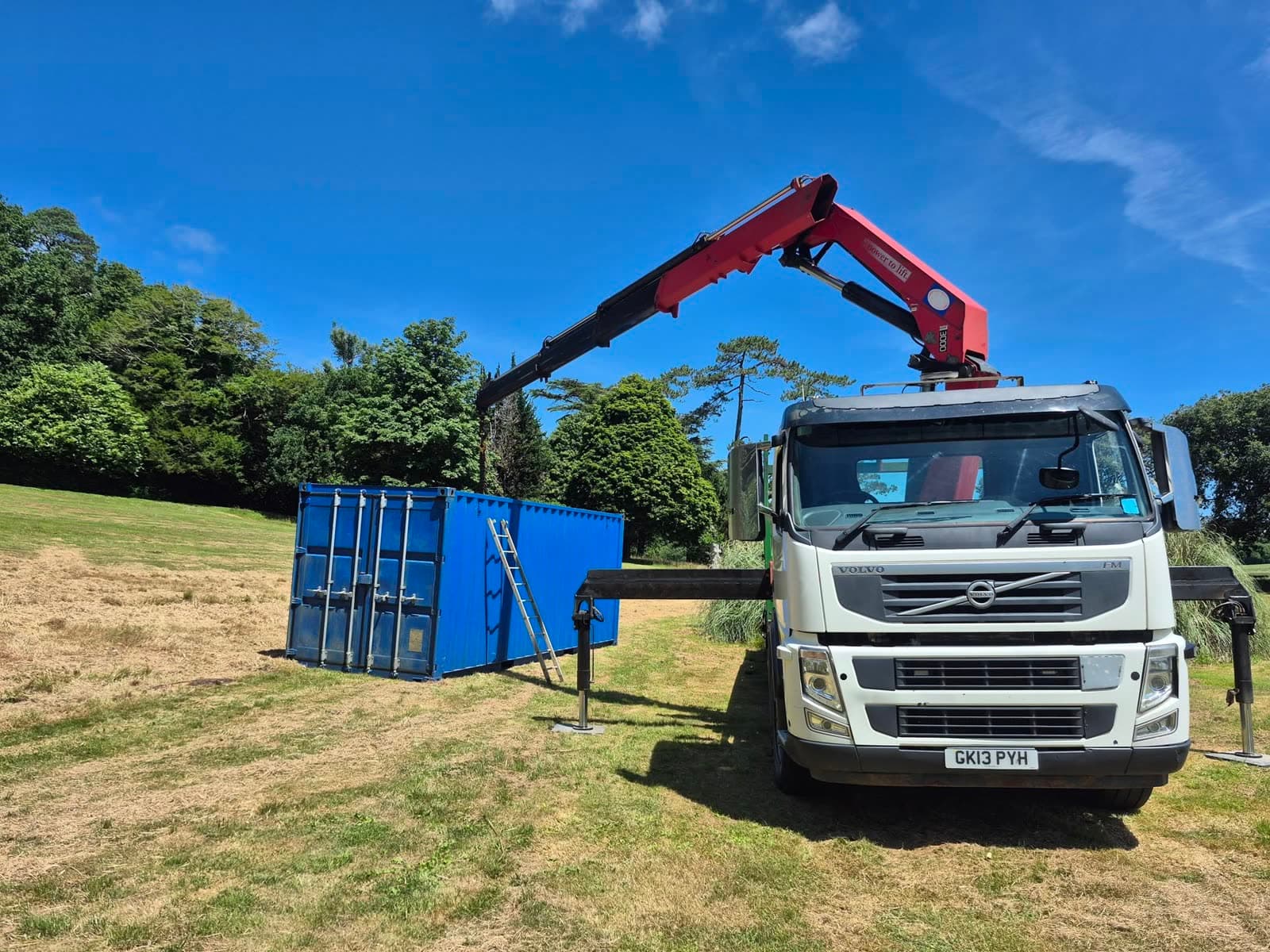 The LCD Haulage & Hiab Hire lorry placing a shipping container with its hiab crane